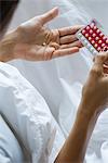 Woman holding birth control pills