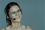 Young woman wearing headset, smiling cheerfully