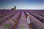 Woman with hat in a lavender field. Plateau de Valensole, Alpes-de-Haute-Provence, Provence-Alpes-Cote d'Azur, France, Europe.