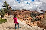 Woman gazing at the landscape from Inspiration Point. Bryce Canyon National Park, Garfield County, Utah, USA.