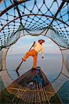 Inle lake, Nyaungshwe township, Taunggyi district, Myanmar (Burma). Local fisherman through the typical conic fishing net.