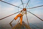 Inle lake, Nyaungshwe, Shan state, Myanmar. Fisherman looking through the fishing net.