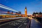 Doubledeckerbus runs towards Big Ben also called Elizabeth Tower, located north end of the Palace of Westminster in London United Kingdom Europe