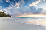 The sky turns pink at sunset and reflected on Ffryers Beach Caribbean Antigua and Barbuda Leeward Islands West Indies