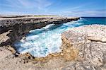 Waves in the natural arches of limestone carved by sea Devil's Bridge Caribbean Antigua and Barbuda Leeward Islands West Indies