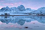 Rakeltinden is reflected in the fjord. Storsteinnes, Balsfjorden, Lyngen Alps, Troms, Norway, Lapland, Europe.