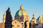Ancient statues frame the dome of Church of Saint Nicholas Prague Czech Republic Europe