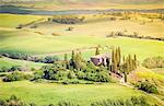 The famous Podere Belvedere under the sunlight, with green hills. Val d'Orcia, Province of Siena, Tuscany, Italy.