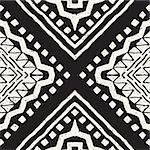 Black and white tribal vector seamless pattern with doodle elements. Aztec abstract geometric art print. Ethnic ornamental hand drawn backdrop.