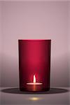 3d illustration of a candle in a red glass with space for your content