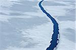 Elevated view of a large crack in pack ice at Snow Hill Island on the Weddel Sea on a sunny day at the Antarctic Peninsula, Antarctica