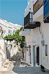 Black cat wandering down an alleyway through traditional white Greek houses, Kastro Village, Sifnos, Cyclades, Greek Islands, Greece, Europe