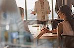 Businesswomen shaking hands in conference room meeting