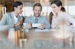 Business people using cell phone in conference room meeting