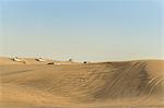 Off road vehicles driving on desert dunes, Dubai, United Arab Emirates