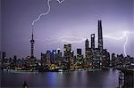 Elevated cityscape with lightning striking oriental pearl tower at night, Shanghai, China