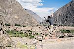 Man Jumping at the top of Ollantaytambo Ruins, Cusco, Peru, South America