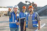 Three quarry workers in discussion, at quarry site