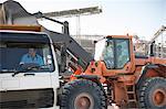 Quarry workers using heavy machinery in quarry