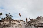 Mother and son diving off cliff, Destin, Florida