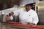 Chef in commercial kitchen preparing cakes