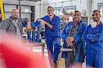 Portrait of male car mechanic team in repair garage