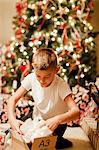 Boy unwrapping gift at Christmas