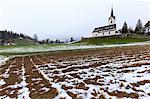 Fields plowed in front of the church. Versam, Safiental, Surselva, Graubunden, Switzerland, Europe