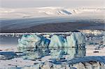 Floating icebergs and Vatnajokull Glacier on the background. Jokulsarlon Glacier Lagoon, Eastern Iceland, Europe