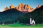 Funes valley, Dolomites, Trentino Alto Adige, Italy. The picturesque small church San Giovanni in Ranui at under of Odle at sunset.