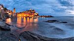 Europe, Italy, Liguria, Cinque Terre, La Spezia. View of Vernazza at dusk