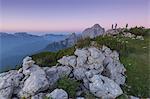 Europe, Italy, Veneto. Hikers on the First Pala di San Lucano summit looking the sunrise. Agordo Dolomites, Belluno, Italy
