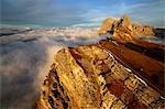 Aerial shot from Seceda of Odle surrounded by clouds at sunset. Dolomites Val Funes Trentino Alto Adige South Tyrol Italy Europe