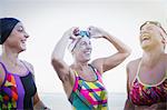 Laughing female open water swimmers