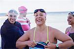 Portrait smiling, confident female open water swimmers drying off with towels