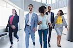 Business people walking in office lobby