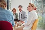 People listening in group therapy session