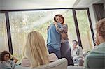 Man and woman hugging in group therapy session