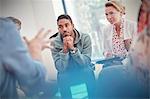 Attentive man and woman listening in group therapy session