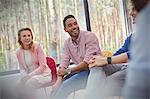 Smiling man listening in group therapy session