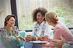Smiling women talking in group therapy session