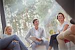 Smiling people talking in group therapy session