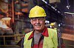 Portrait smiling, confident steelworker in steel mill