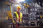 Portrait serious, confident steelworker in steel mill