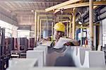 Steelworker with clipboard in steel mill