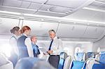 Pilot and flight attendants talking, preparing on airplane