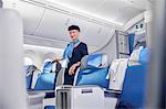 Portrait confident female flight attendant on airplane