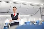 Portrait smiling, confident female flight attendant on airplane