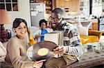 Couple looking at vinyl records in living room