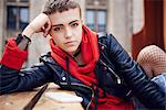 Portrait of cool young woman with short hair at city bench